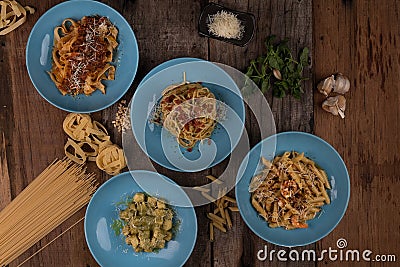Top view variety of homemade prepared pasta isolated on wooden table Stock Photo