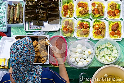 Top view of vendor preparing Yellow Rice package at the food stall in Kota Kinabalu city food market Editorial Stock Photo