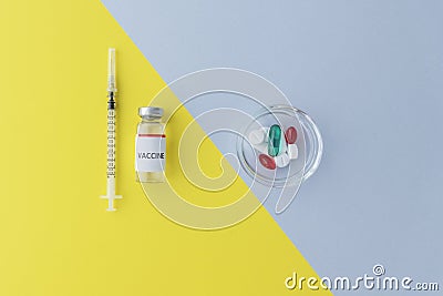 top view of vial with vaccine and syringe on yellow background, plate with pills on grey background, comparison of two methods of Stock Photo
