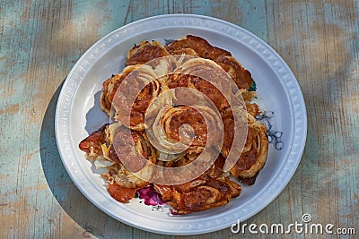 Top view on vintage porcelain plate with homemade italian style pizza scrolls. Stock Photo