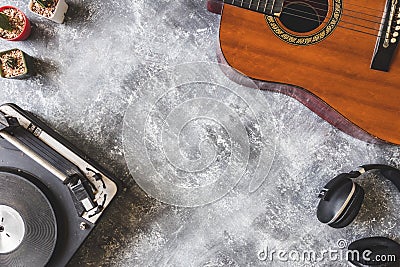 Top view of Vintage Turntable with Guitar,headphone and cactus on grunge background. Stock Photo