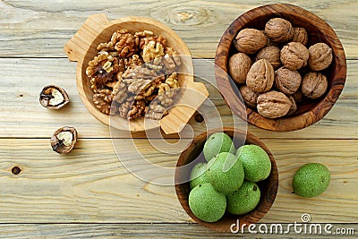 Walnuts green and dry on kitchen table background Stock Photo