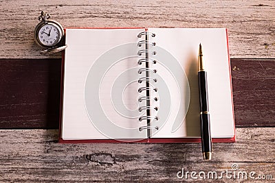 Top view and warm tone. pen putting empty notebook red cover and Stock Photo