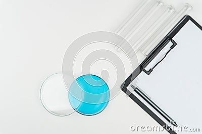 Top view of a watch glass with blue liquid Stock Photo