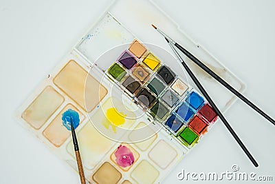 Top view of watercolor palette. Paintbrushes mixing colors to paint Stock Photo