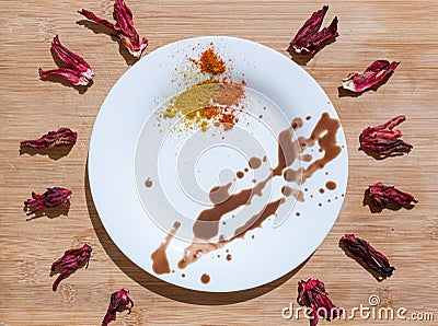 Well composed dried hibiscus flowers with decorated white plate in the middle Stock Photo