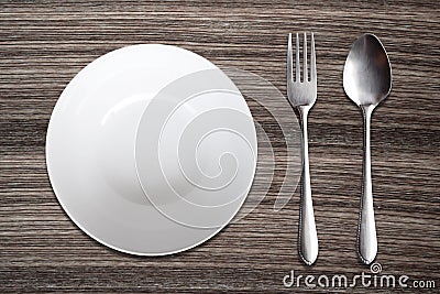 Top view White Bowl spoon fork on wood background Stock Photo