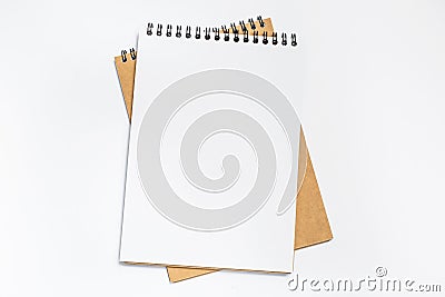 Top view of white desk with blank notebook in the middle. Stock Photo