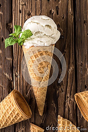 Top view white ice cream in waffle cone on rustic background Stock Photo