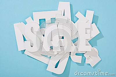 Top view of white sale word on pile of letters on blue background. Stock Photo