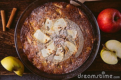 Top view of whole homemade apple pie on rustic brown burlap fabric with soft natural light, with apples and cinnamon sticks, Stock Photo