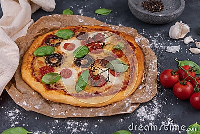 Top view of whole vegetarian pizza with mushrooms, basil, tomatoes, and cheese Stock Photo