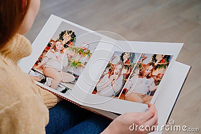 top view. woman flips through pages of photobook from photo shoot pregnancy Stock Photo