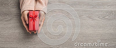 Top view of Woman hands is holding a small red gift box Stock Photo