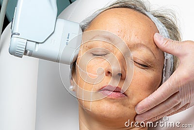 Top view of middle aged woman having facial hifu energy treatment Stock Photo