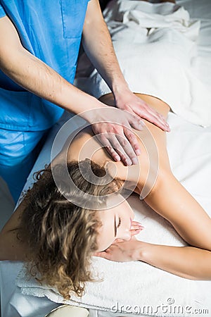 Top view of woman receiving back massage at spa. Female having relaxing massage on her back in spa. Stock Photo