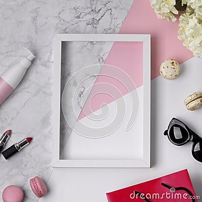 Top view of woman`s beauty desk with frame, accessories, decorative cosmetic, flowers and sweets Stock Photo