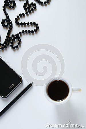 Top view of women`s business work desk. Flat lay fashion feminine workspace with phone, cup of coffee, pen and jewelry Stock Photo