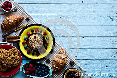 Top view of a wood table full of cakes, fruits, coffee, biscuits Stock Photo