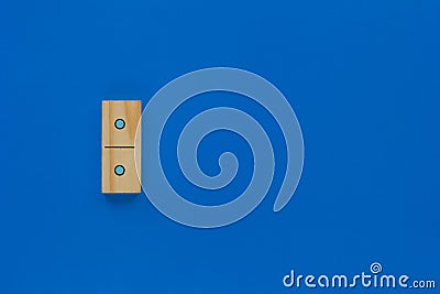 Top view of wooden dominoes gaming double piece with one spot on with copy space on the blue background Stock Photo