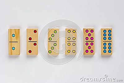 Top view of wooden six dominoes gaming pieces with double spots on it on the white background Stock Photo