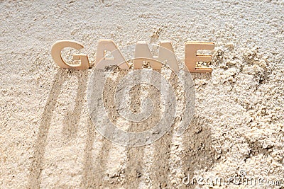 Top view on the word game, long shadows on the sand Stock Photo