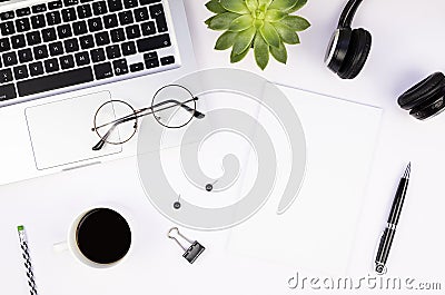 Top view work office desk with silver aluminum laptop, blank magazine cover mockup, glasses and coffee cup Stock Photo