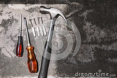 Top view working tools, hammer, screwdrivers and plastic anchors on cement background Stock Photo