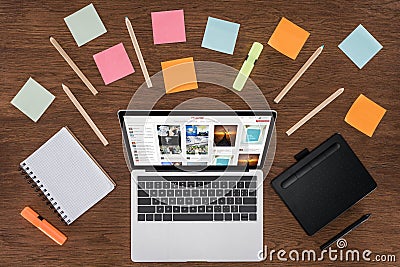 top view of workplace with arranged textbooks post it and laptop with pinterest Editorial Stock Photo