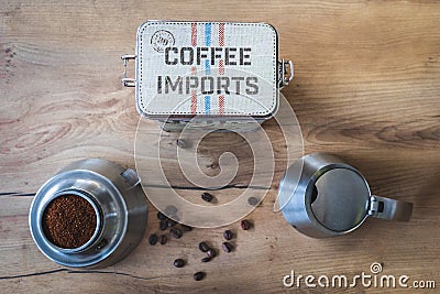 Topdown shot of coffee canister surrounded by a Bialetti and some coffee beans Editorial Stock Photo