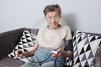 The topic is very old person and health problems. A senior Caucasian woman, 90 years old, with wrinkles and gray hair Stock Photo