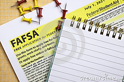 Topview photo of FAFSA - free application for federal student aid, and open notepad with blank space Editorial Stock Photo