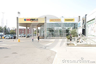 tor, canada - august 19, 2023: no frills wont be beat grocery store chain franchise pharmacy facade yellow 120 p 20 h Editorial Stock Photo