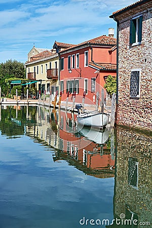 Torcello, Venice. Colorful houses on Torcello island, canal and boats. Italy Stock Photo