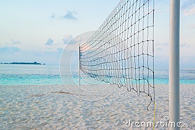 Torn beach volleyball net at tropical beach Stock Photo