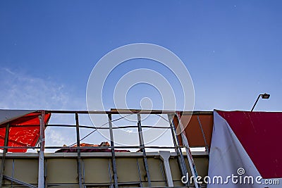 Torn Billboard developing in the air against the blue sky Stock Photo