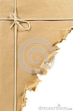 Torn brown paper parcel or package, white background, copy space, vertical Stock Photo