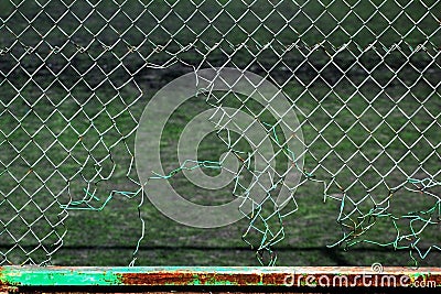 Torn chain link fence. Hole in mesh netting Stock Photo