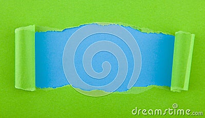 Torn green paper isolated on blue background Stock Photo