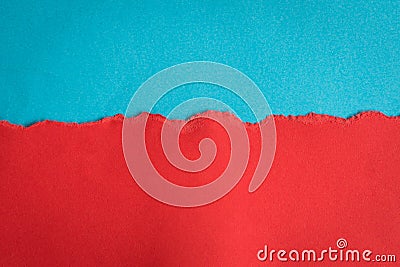 Torn half sheet red paper horizontal on blue paper at the bottom Stock Photo