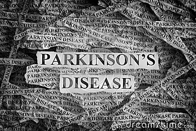 Torn pieces of paper with the words Parkinson`s disease Stock Photo