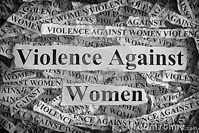 Torn pieces of paper with the words Violence Against Women Stock Photo