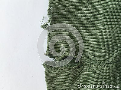 Torn shabby fabric on a white background. Minimalistic wallpaper. Stock Photo