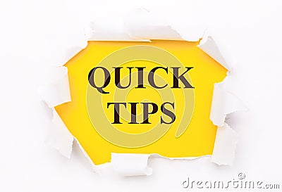 Torn white paper lies on a bright yellow background with the text QUICK TIPS Stock Photo