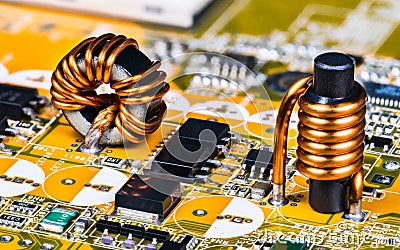 Toroidal and cylindrical inductor on circuit board of computer mainboard detail Stock Photo