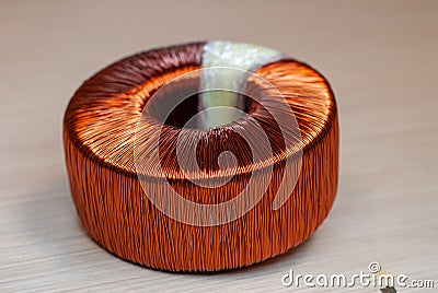 Toroidal transformer, composed of wrapped copper coil Stock Photo
