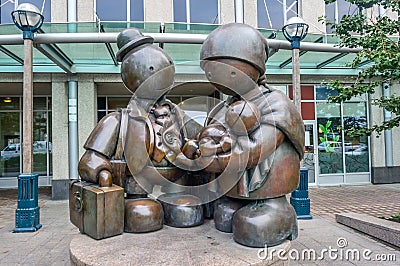 Toronto, Canada - August 15,2015: The bronze Immigrant Family sculpture by Tom Otterness on Yonge Street. Editorial Stock Photo