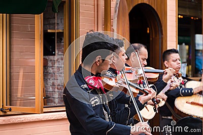 TORONTO, ON, CANADA - JULY 29, 2018: A mariachi band plays in front of a crowd in Toronto`s vibrant Kensington Market. Editorial Stock Photo