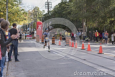 TORONTO, ON/CANADA - OCT 22, 2017: Marathon runner Roy passing t Editorial Stock Photo