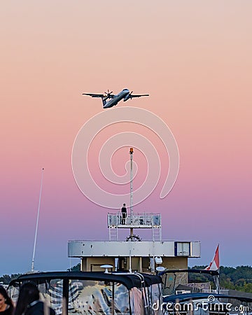 Porter propellor airplane departing Billy Bishop Airport just after sunset. De Havilland Canada Dash 8 Q400 Editorial Stock Photo